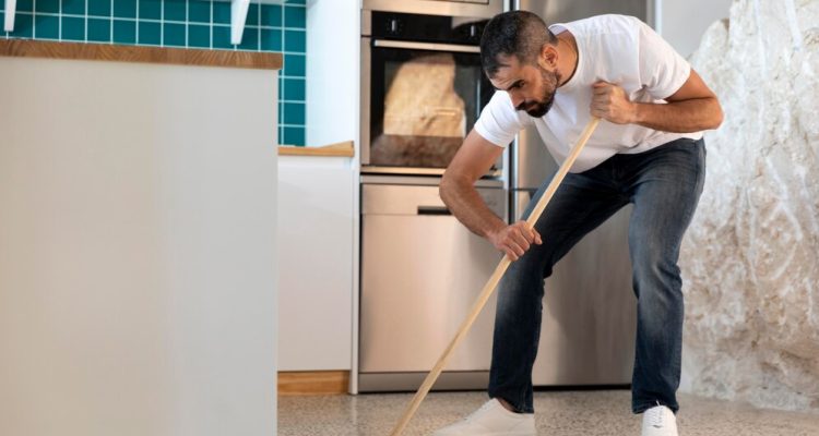 full-shot-man-cleaning-kitchen_23-2148931342