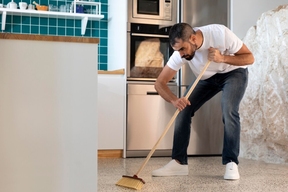 full-shot-man-cleaning-kitchen_23-2148931342