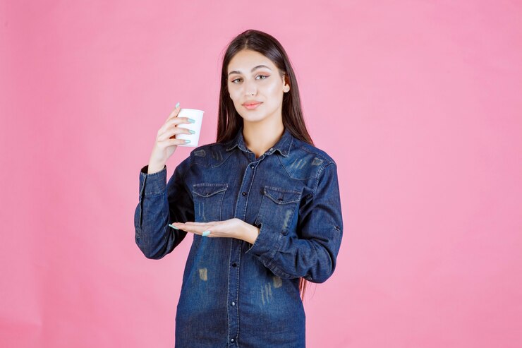 girl-denim-shirt-holding-coffee-cup-feels-positive_144627-55329