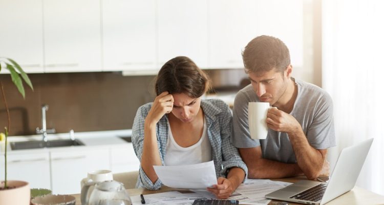 young-couple-checking-their-family-budget_273609-12829