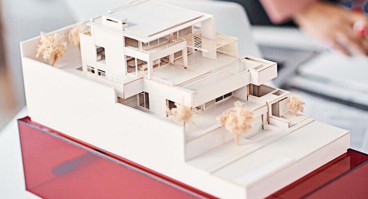 architecture-closeup-model-modern-house-desk-with-people-planning-vision-real-estate-design-engineering-development-property-agency-expansion-presentation-office_590464-336750