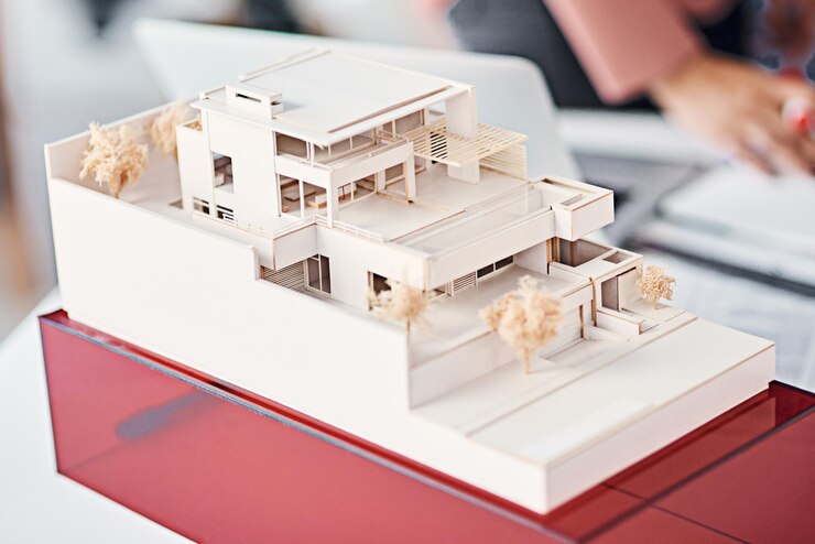 architecture-closeup-model-modern-house-desk-with-people-planning-vision-real-estate-design-engineering-development-property-agency-expansion-presentation-office_590464-336750