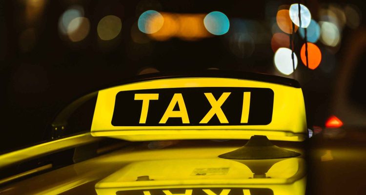 black-yellow-sign-taxi-night-placed-top-car_11zon