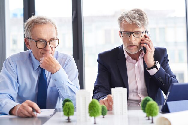 shocked-businessman-talking-by-mobile-phone-business-meeting_329181-19337