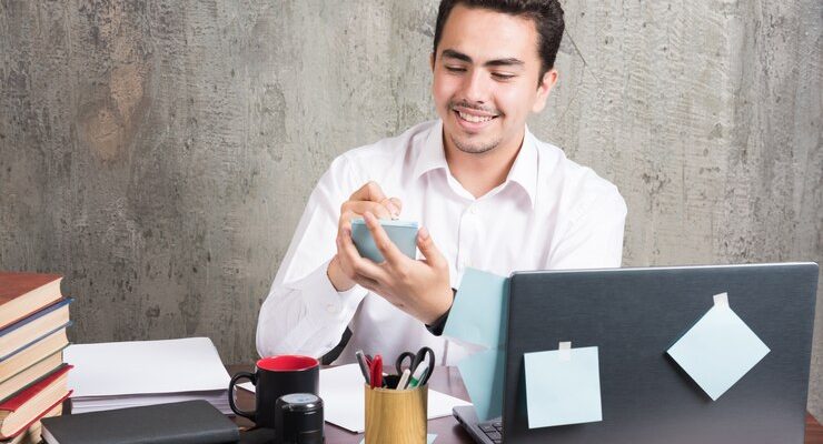 office-employee-playing-with-telephone-office-desk_114579-28385