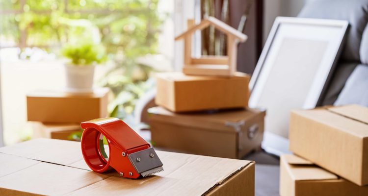 stack-of-cardboard-boxes-in-living-room-at-new-hou-2021-10-06-09-52-25-utc-scaled