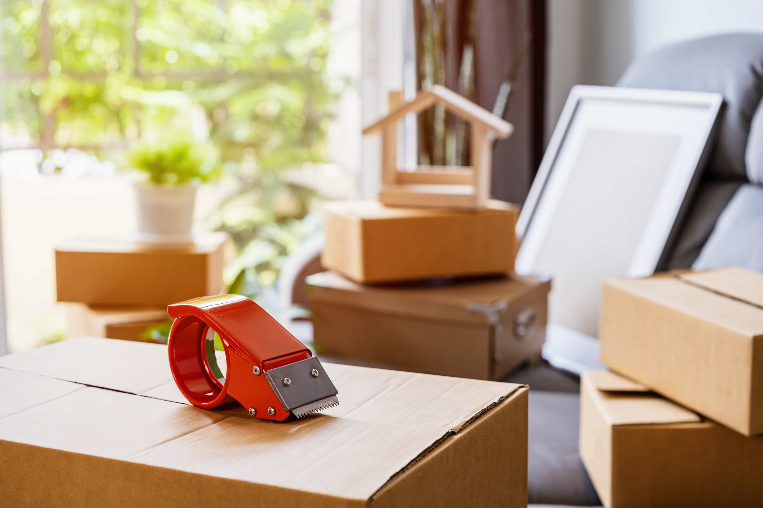 stack-of-cardboard-boxes-in-living-room-at-new-hou-2021-10-06-09-52-25-utc-scaled