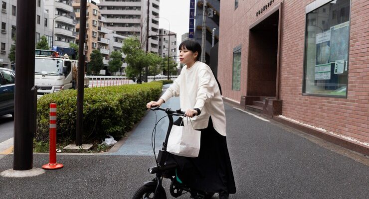 woman-using-electric-bicycle-city_23-2149026652