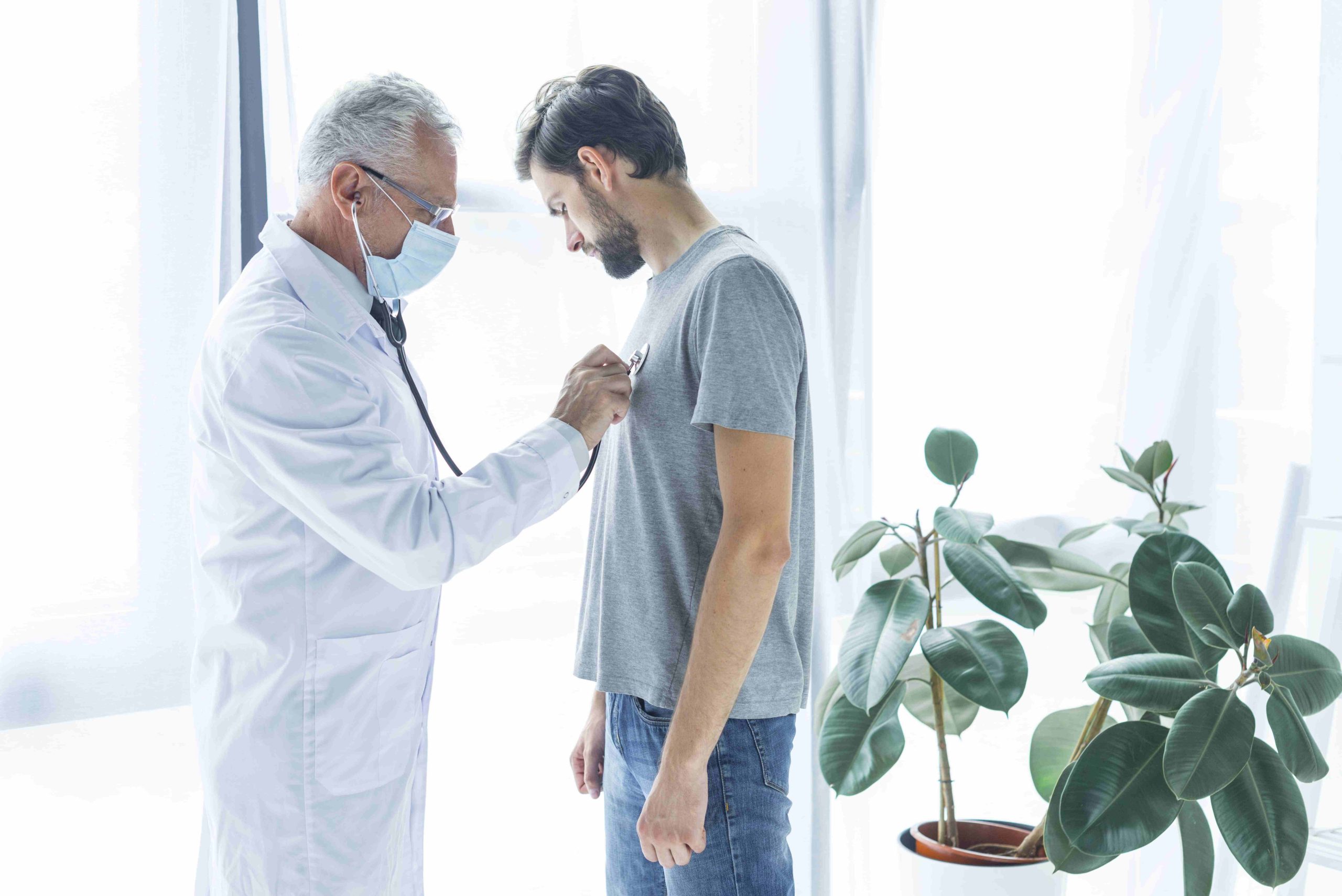 doctor-examining-chest-patient (1) (1)