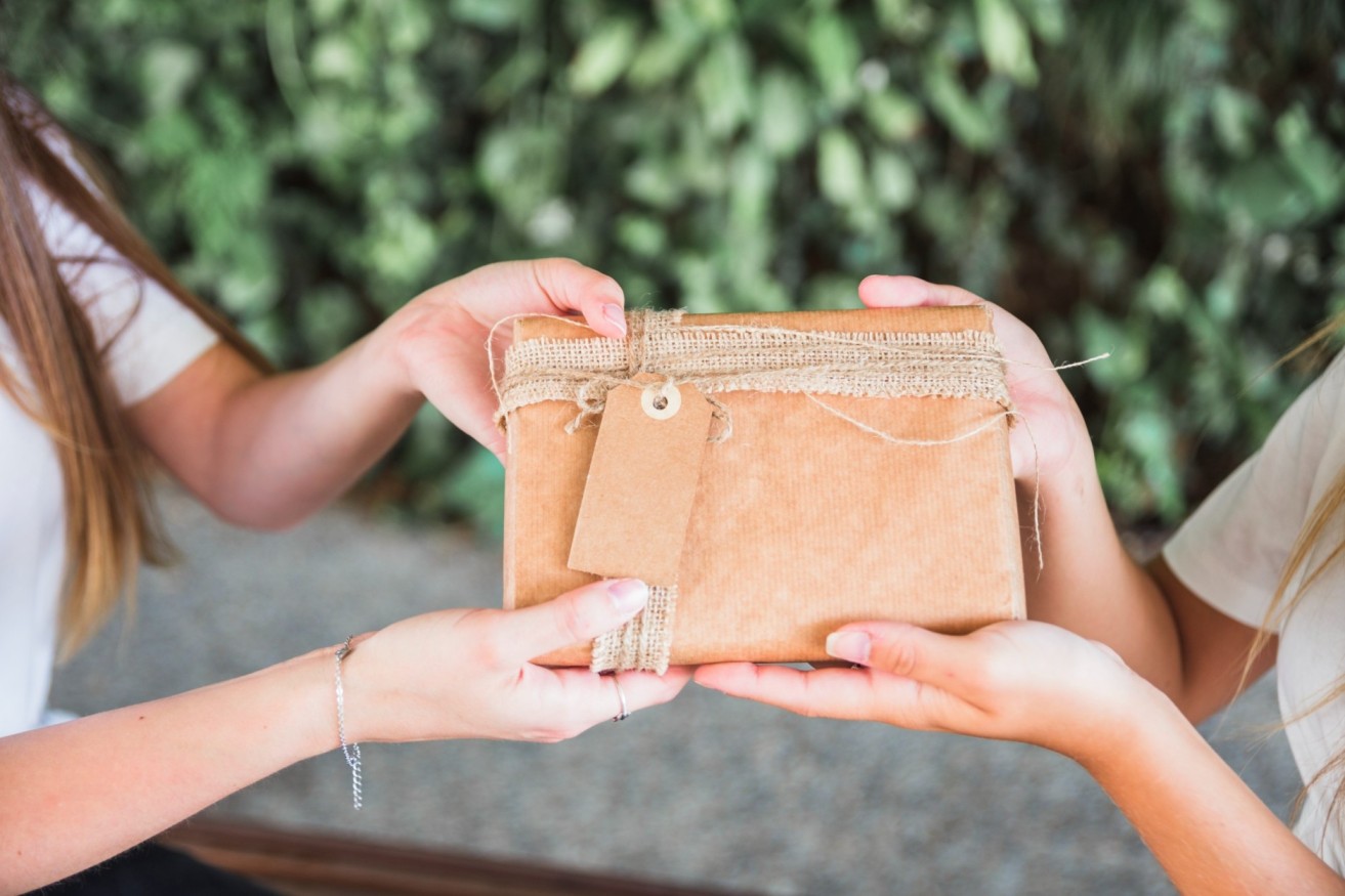 close-up-two-women-s-hand-holding-brown-gift-box (1) (1) (1) (1)