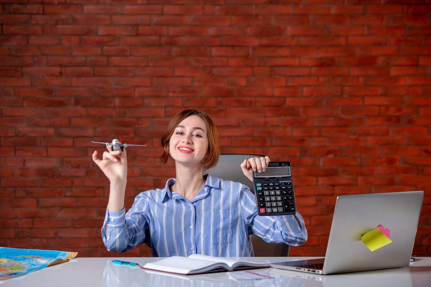 front-view-travel-agent-sitting-her-working-place-holding-toy-plane-calculator-agency-service-assistant-map-operator-global-world-ticket-managers1