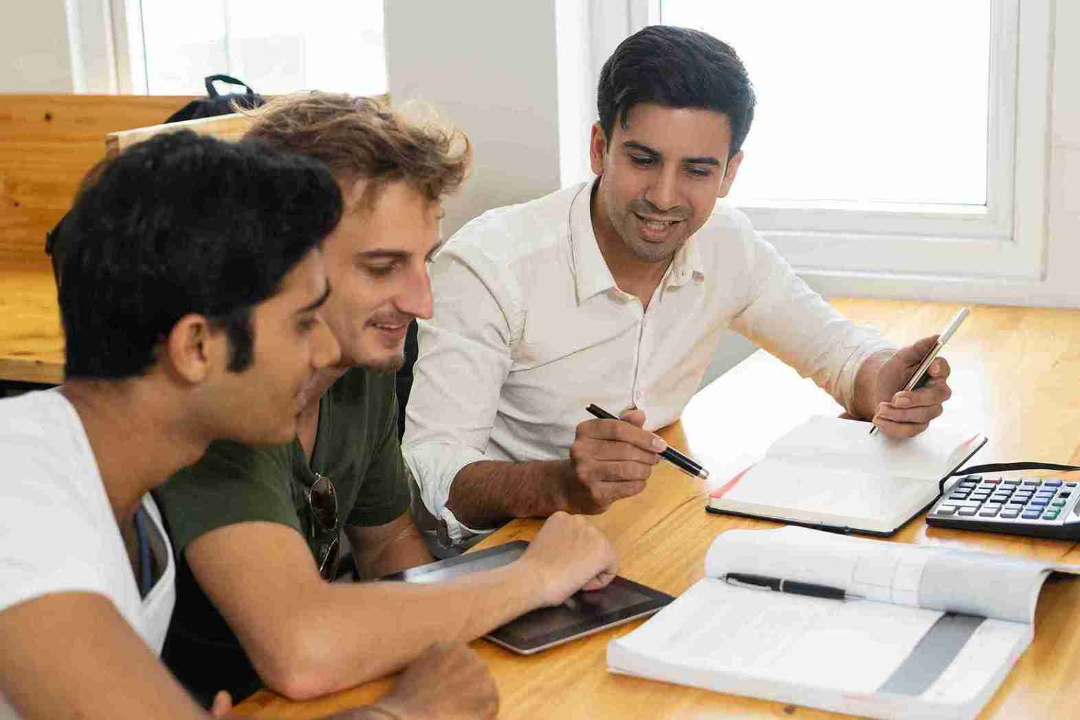 young-teacher-telling-two-students-about-corporate-budgeting_11zon