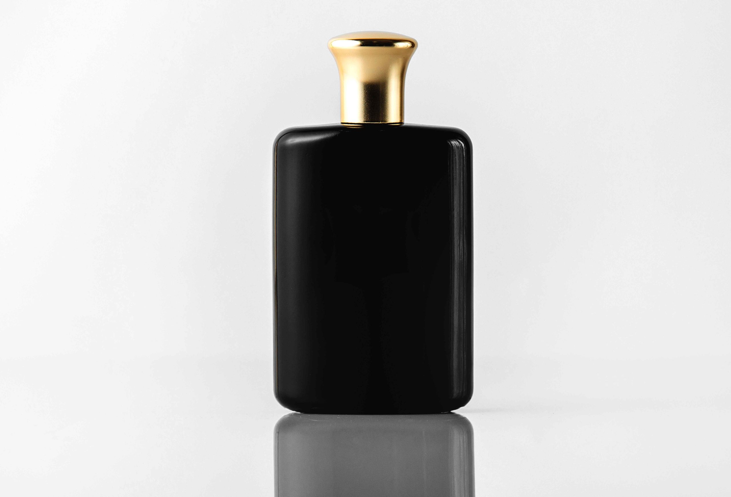 front-view-black-fragrance-designed-with-gold-cap-white-floor_11zon