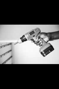 man-using-electronic-drill (1)